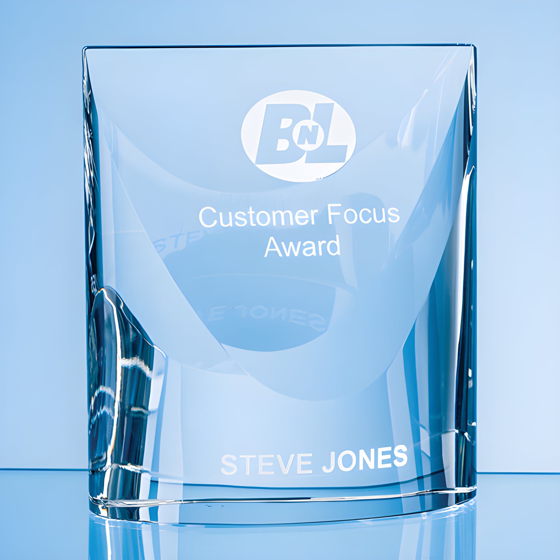 Optical crystal award with 'Customer Focus Award' and 'Steve Jones' engraved.