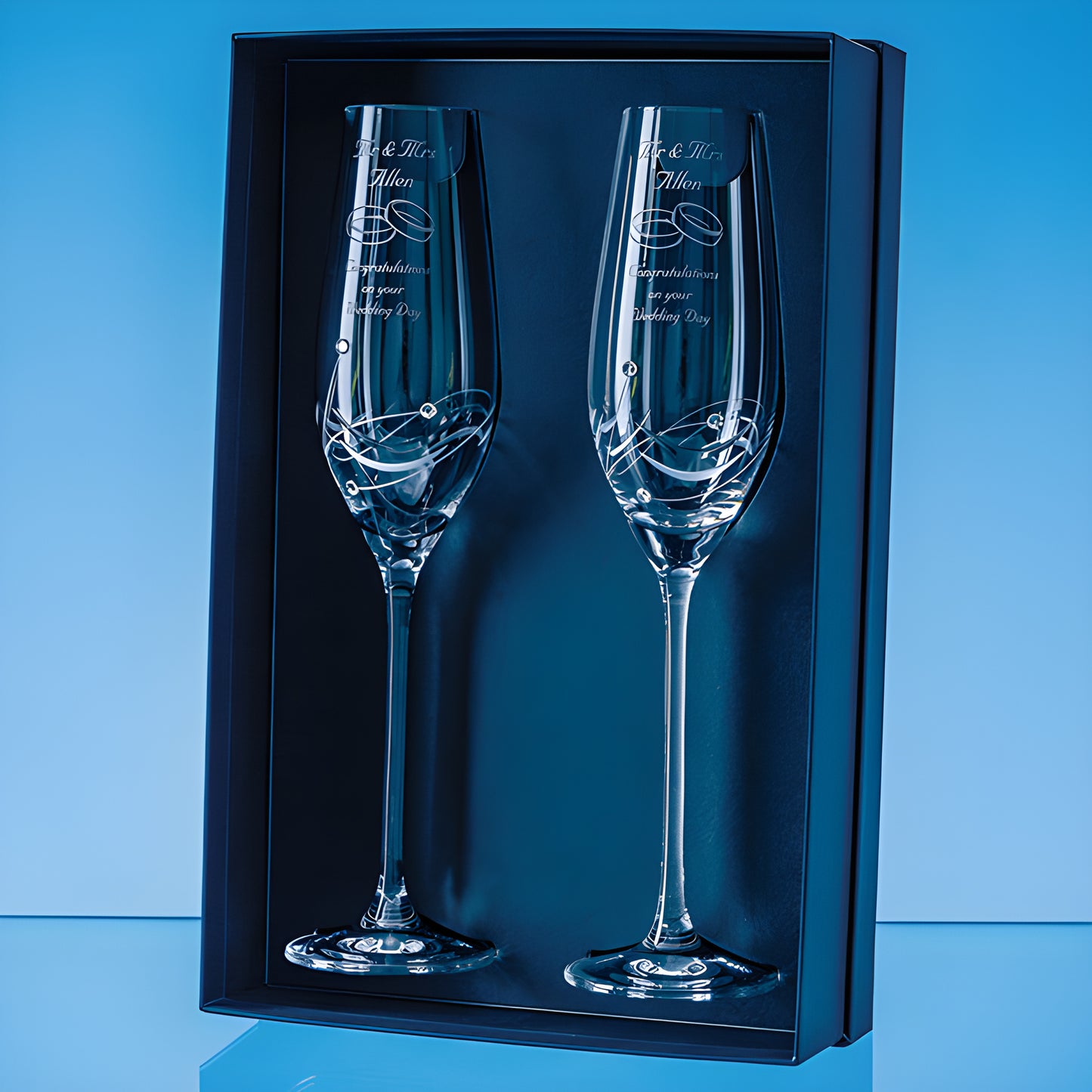 Custom engraved diamante champagne flutes with elegant spiral design in a gift box.