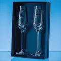 Two engraved champagne flutes with spiral cut design in a gift box.