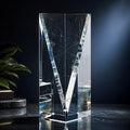 Clear optical crystal award with facet design on a dark background