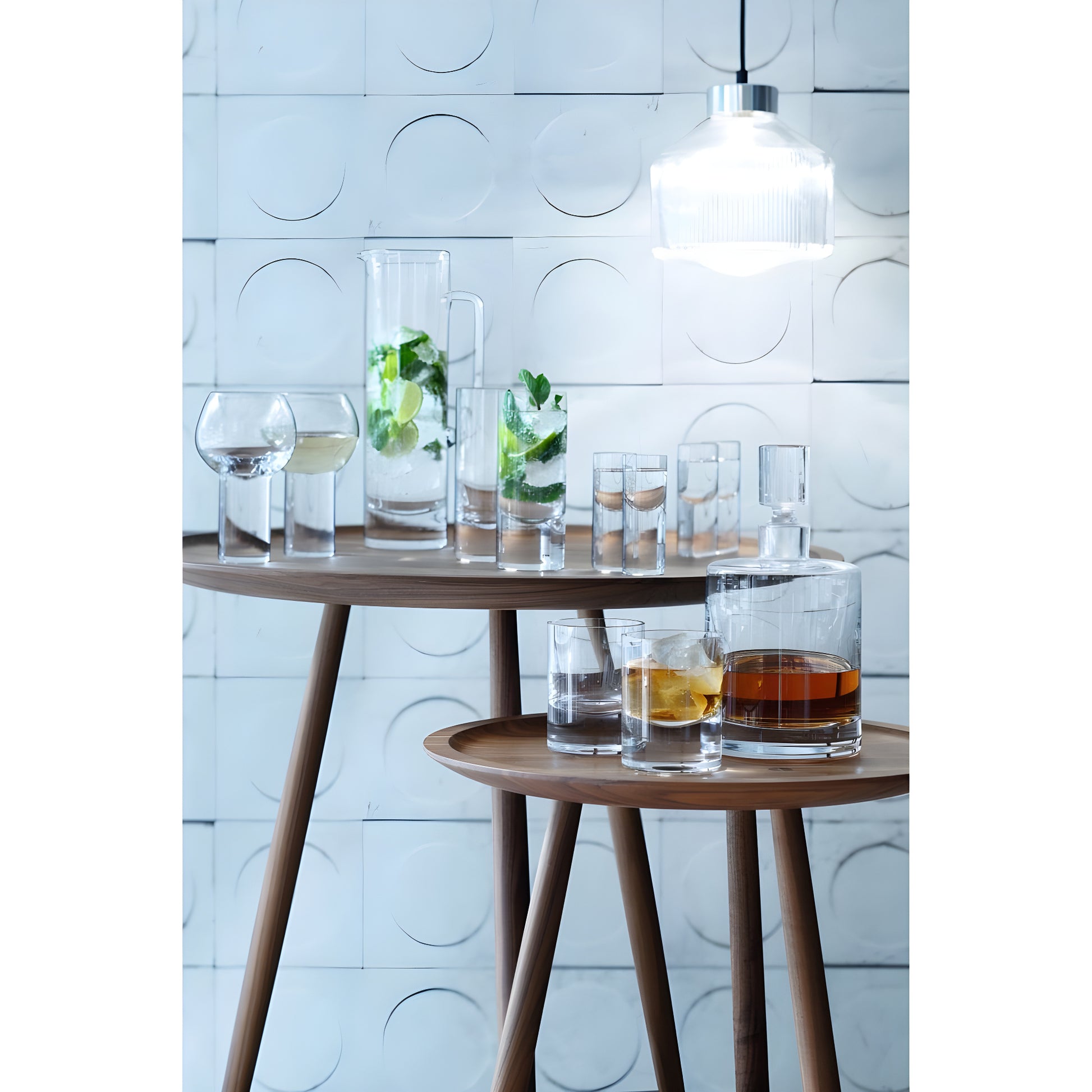 Modern glassware including decanter and glasses on wooden table set.