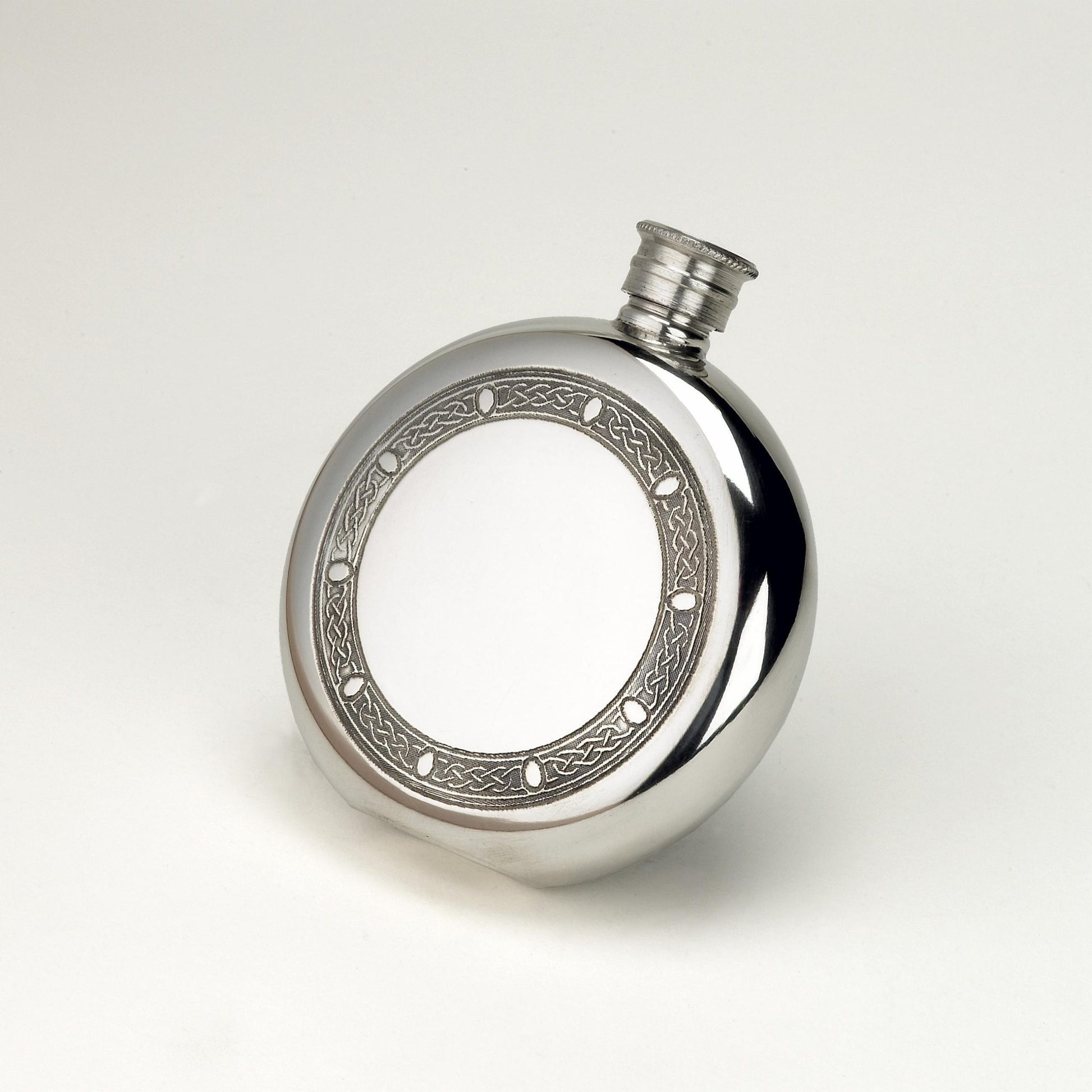 Round stainless steel hip flask with Celtic engraved frame design.