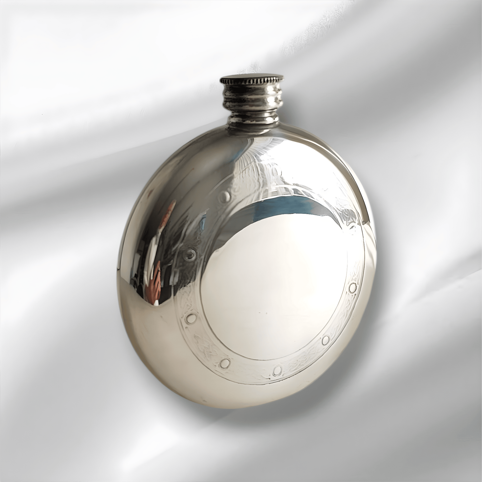 Stainless steel 6oz hip flask with Celtic frame design on white background.