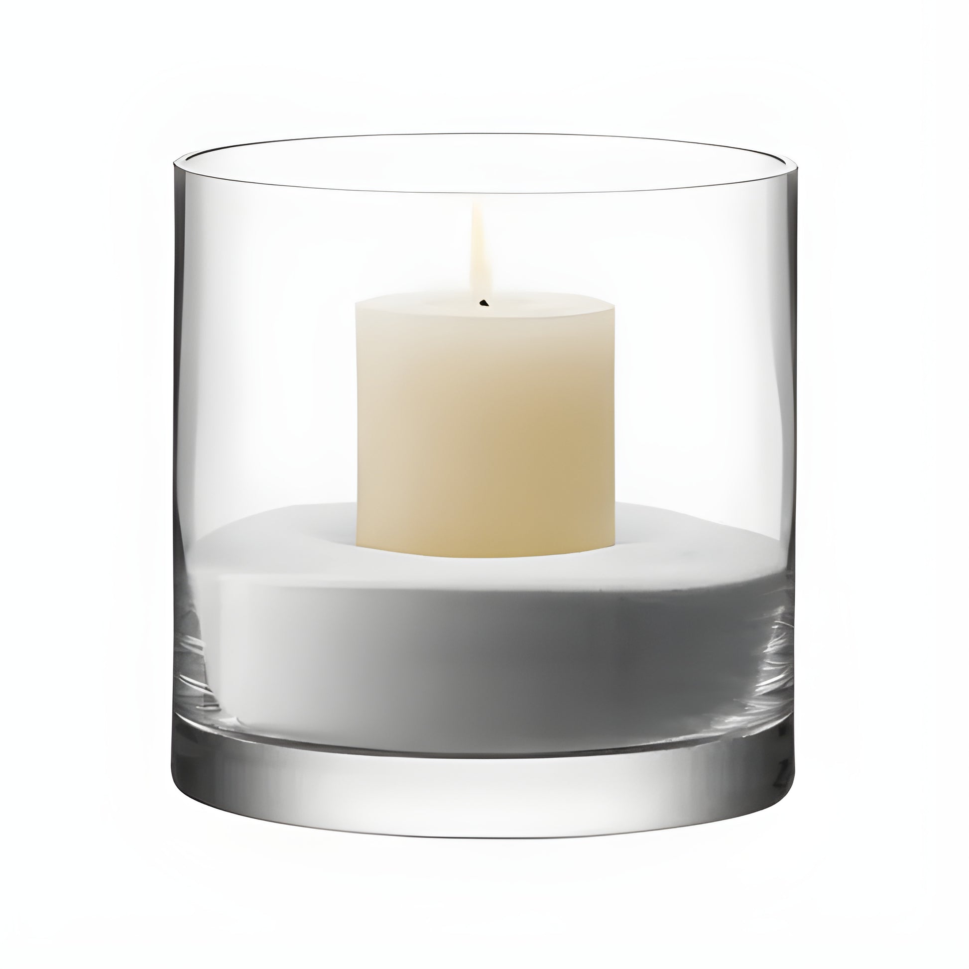 Glass cylinder candle holder with a white pillar candle inside.