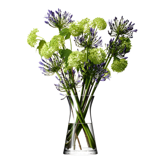 Purple and green flower arrangement in a clear glass vase.