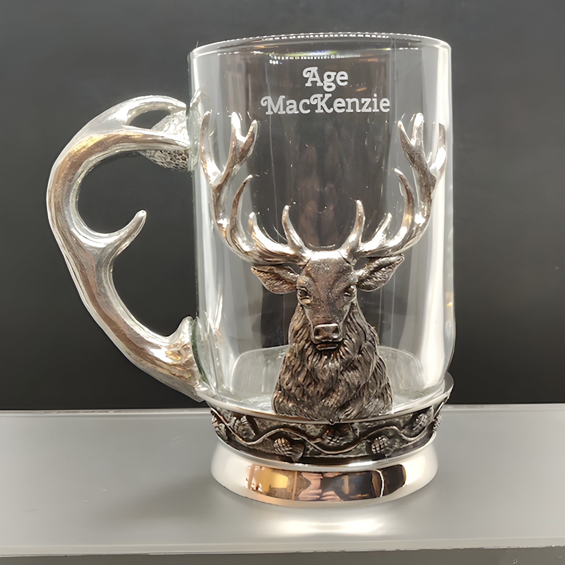 Glass and pewter tankard with stag and antler handle, engraved with 'Age MacKenzie'.