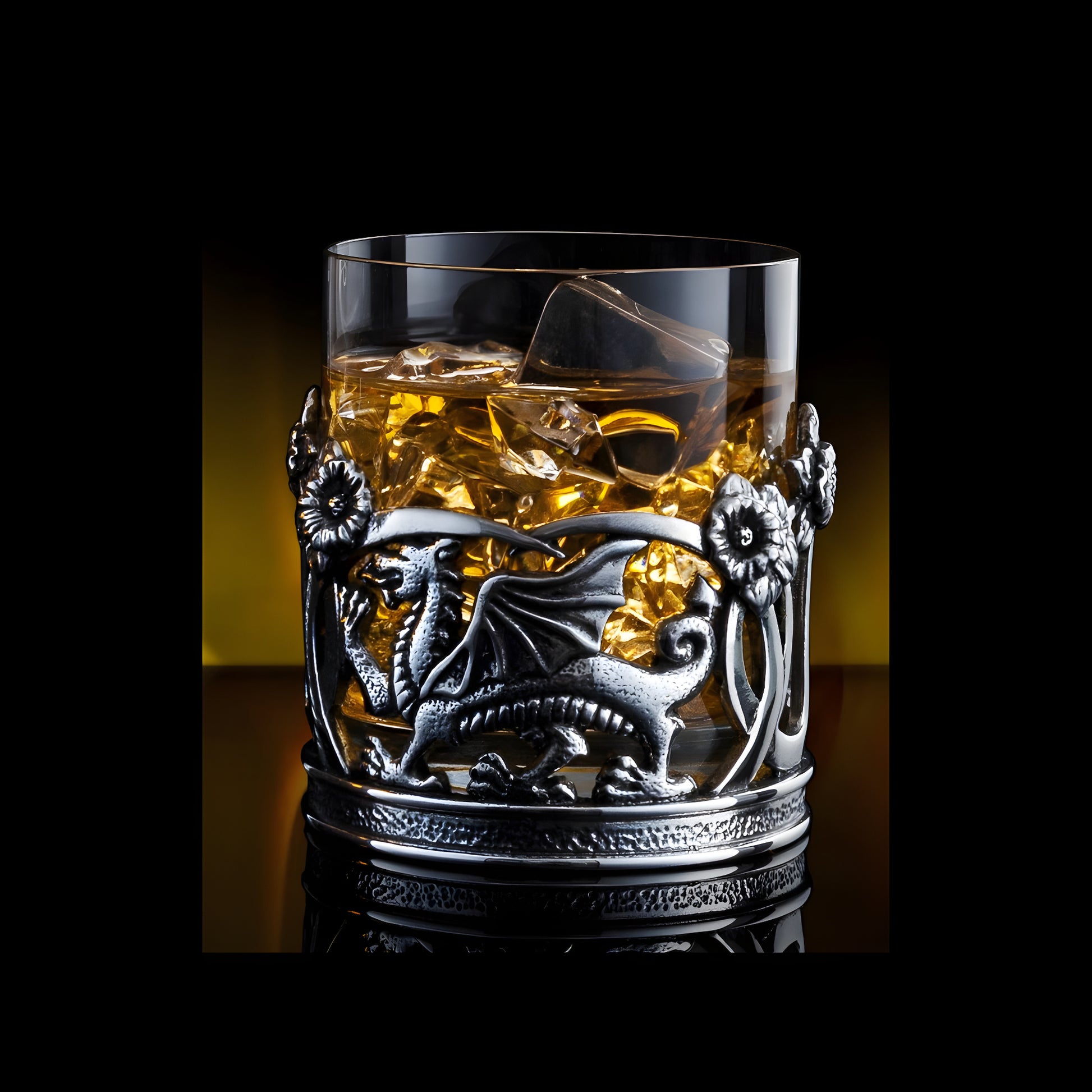 Pewter dragon whisky tumbler with ice and amber liquid.