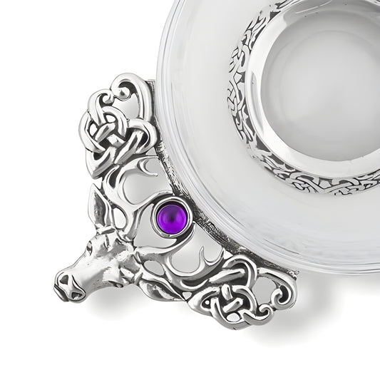 Glass stag quaich with Celtic design and purple gemstone.