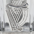Silver Irish harp ornament on a glass decanter.