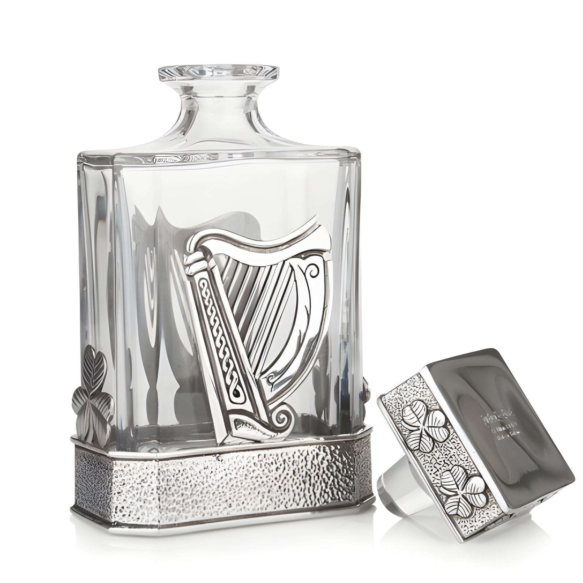 Elegant glass decanter with silver Irish harp and clover accents.