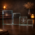 Engraved jade glass award for primary school on a wooden table with candlelight.