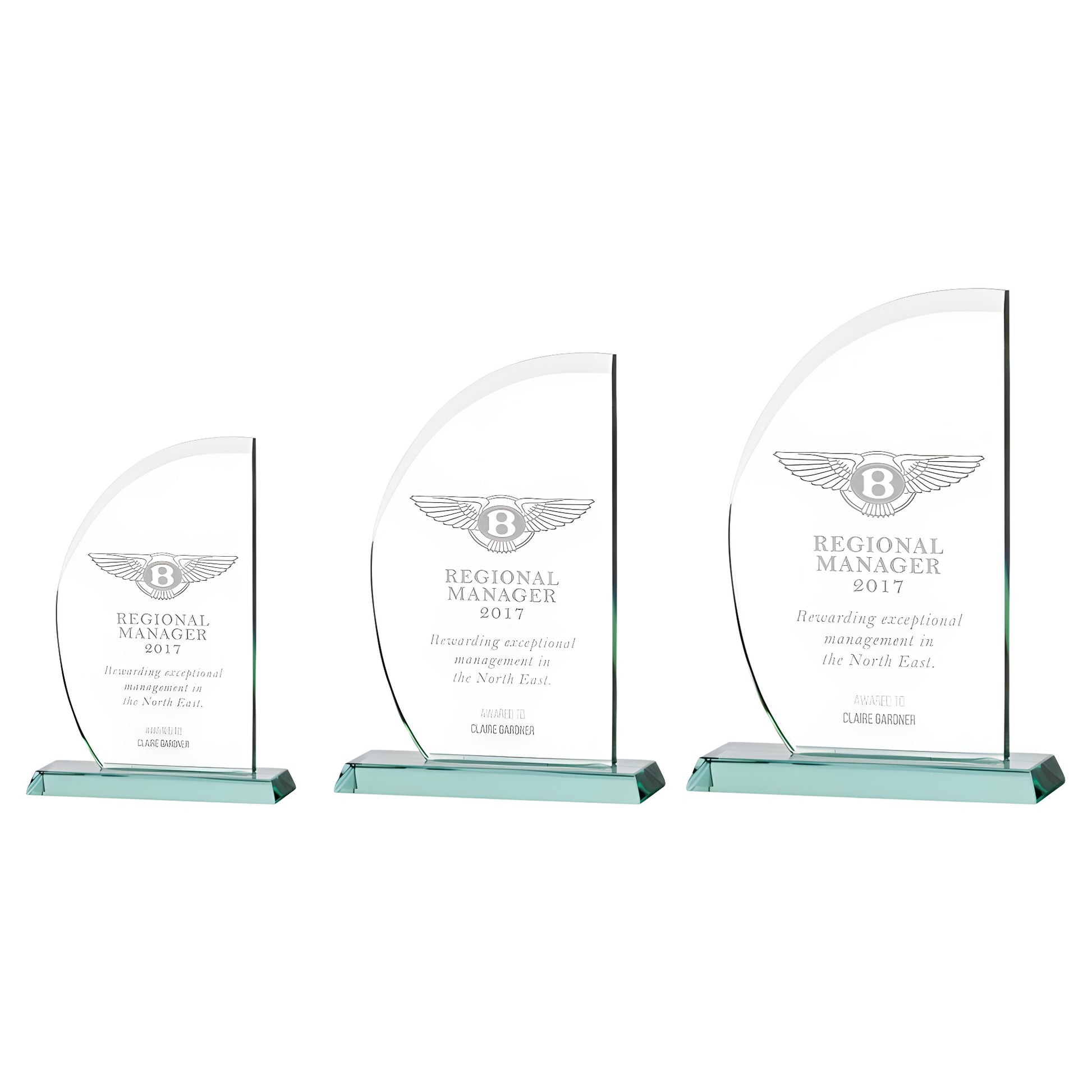 Three engraved glass awards for Regional Manager 2017 with jade bases.