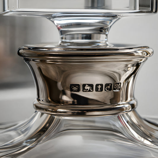 Close-up of a crystal bourbon decanter with hallmarks on the neck.
