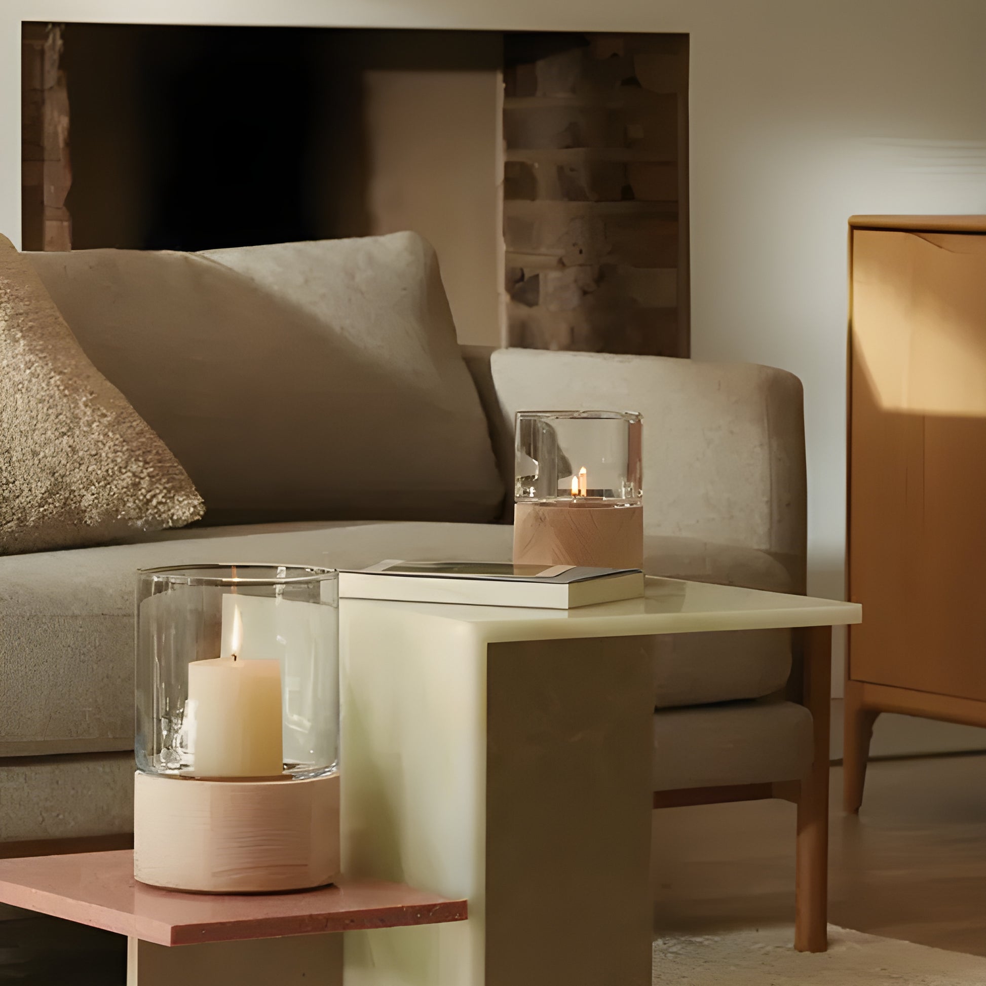 Modern living room with glass and wood candle holders on side table.