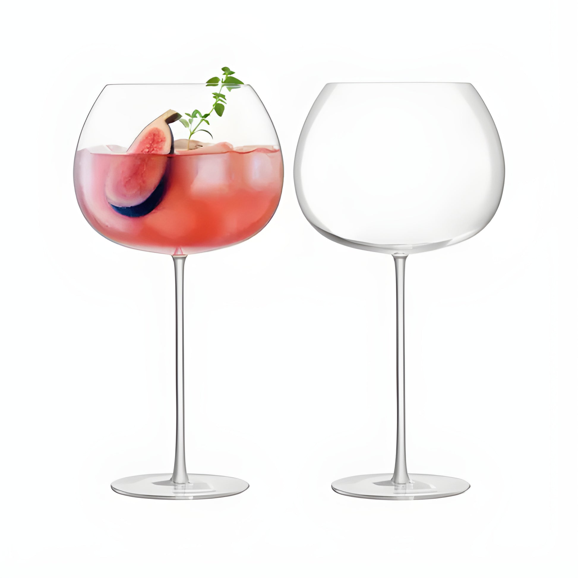 Set of two balloon glasses with pink gin and fig garnish.