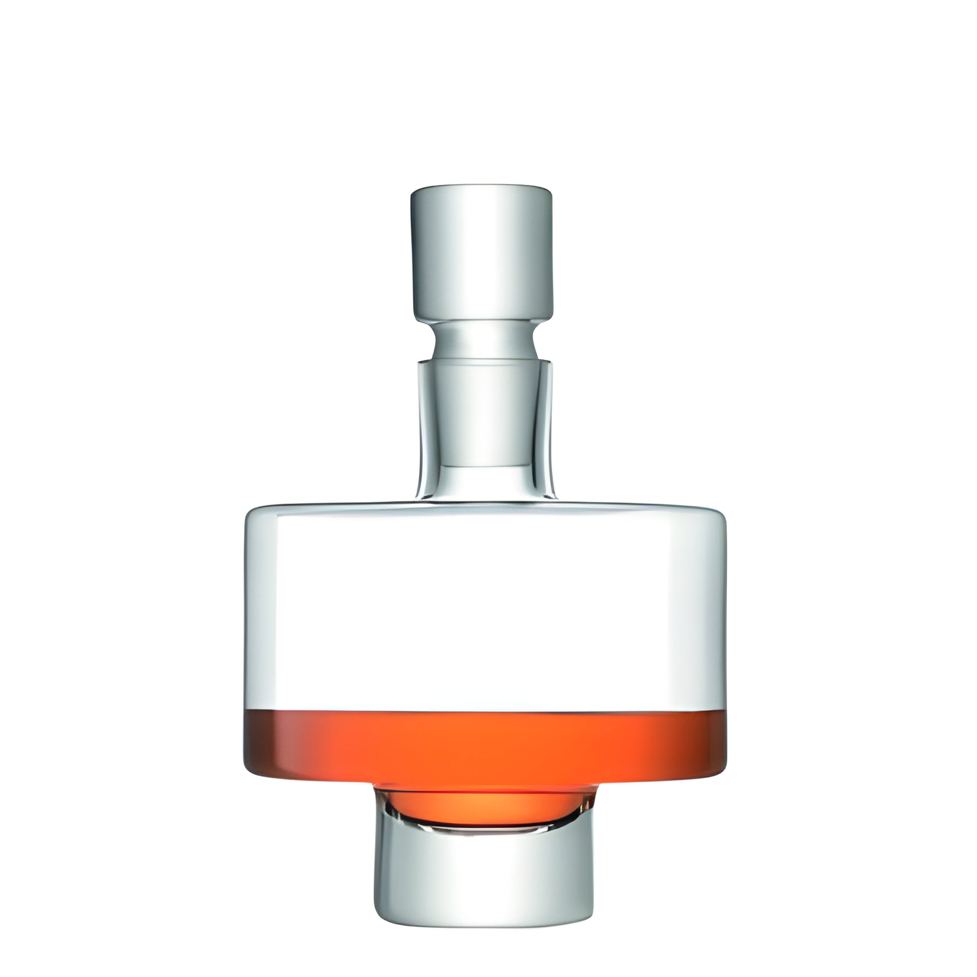 Modern glass decanter with stopper holding red liquid against white background.