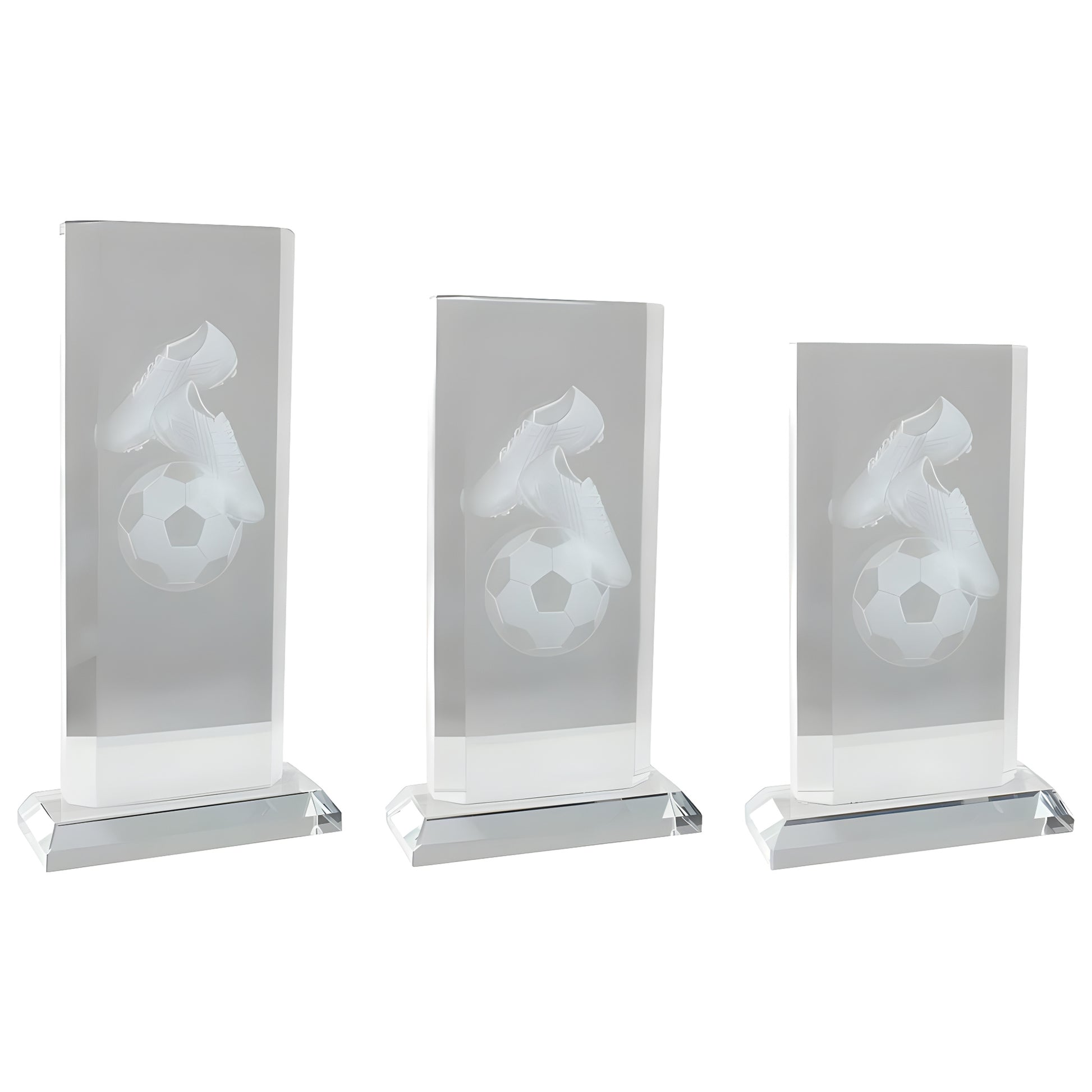 Three crystal awards with engraved soccer shoes and ball motif.