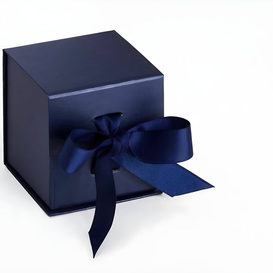 Navy blue cube gift box with a blue ribbon bow on a white surface.