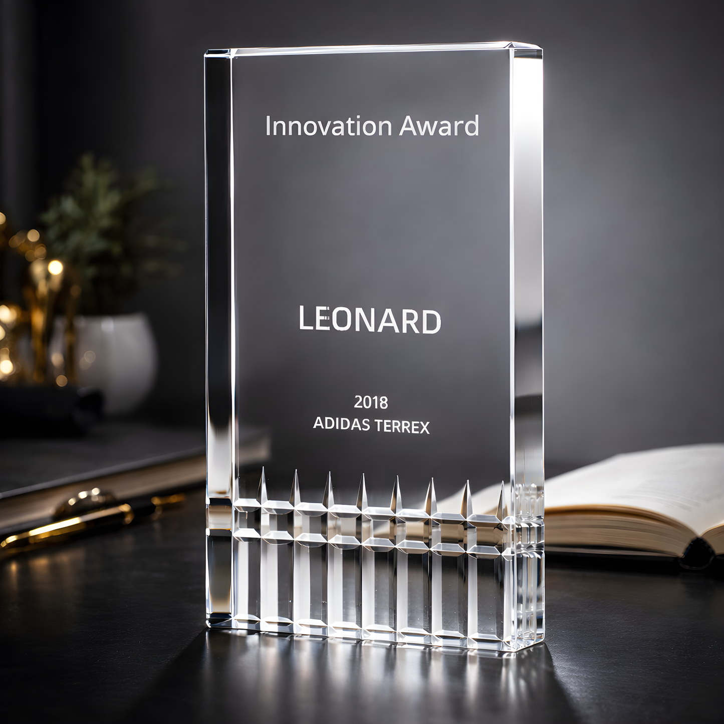 Cut glass innovation award trophy with personalized engraving on table.