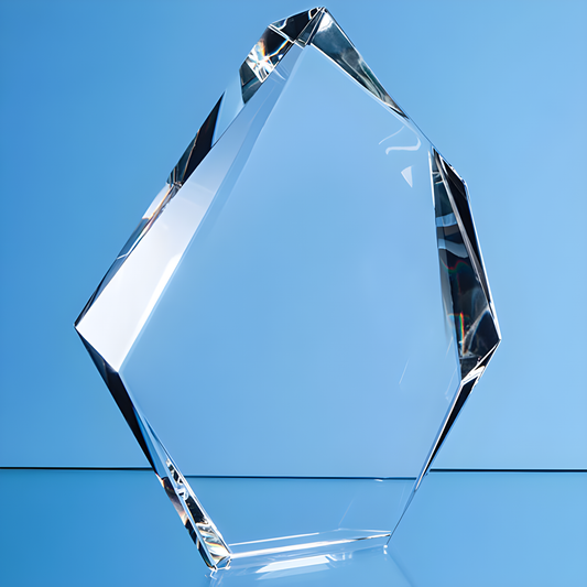 Clear facetted glass award trophy on a blue background.