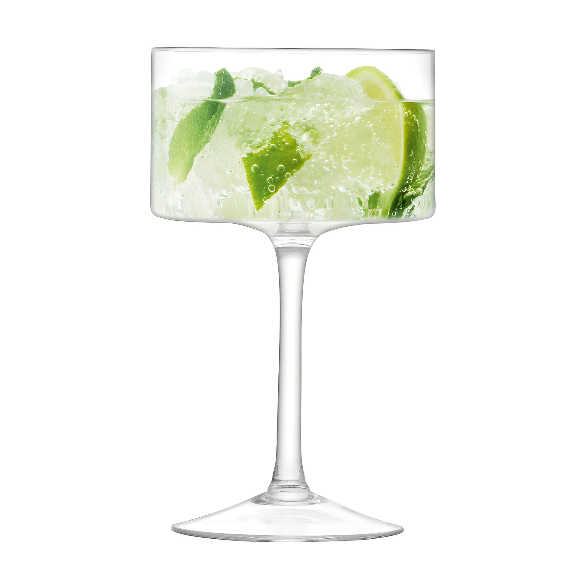 Single glass of champagne cocktail with lime and mint garnish on a clear background.