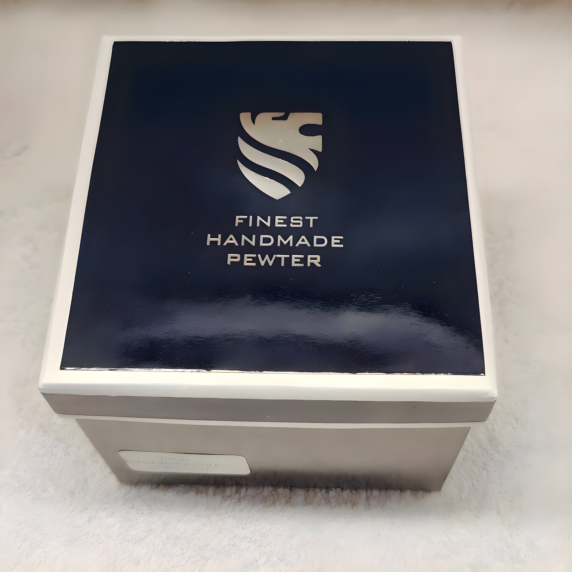 Finest handmade pewter box with lion emblem on lid.