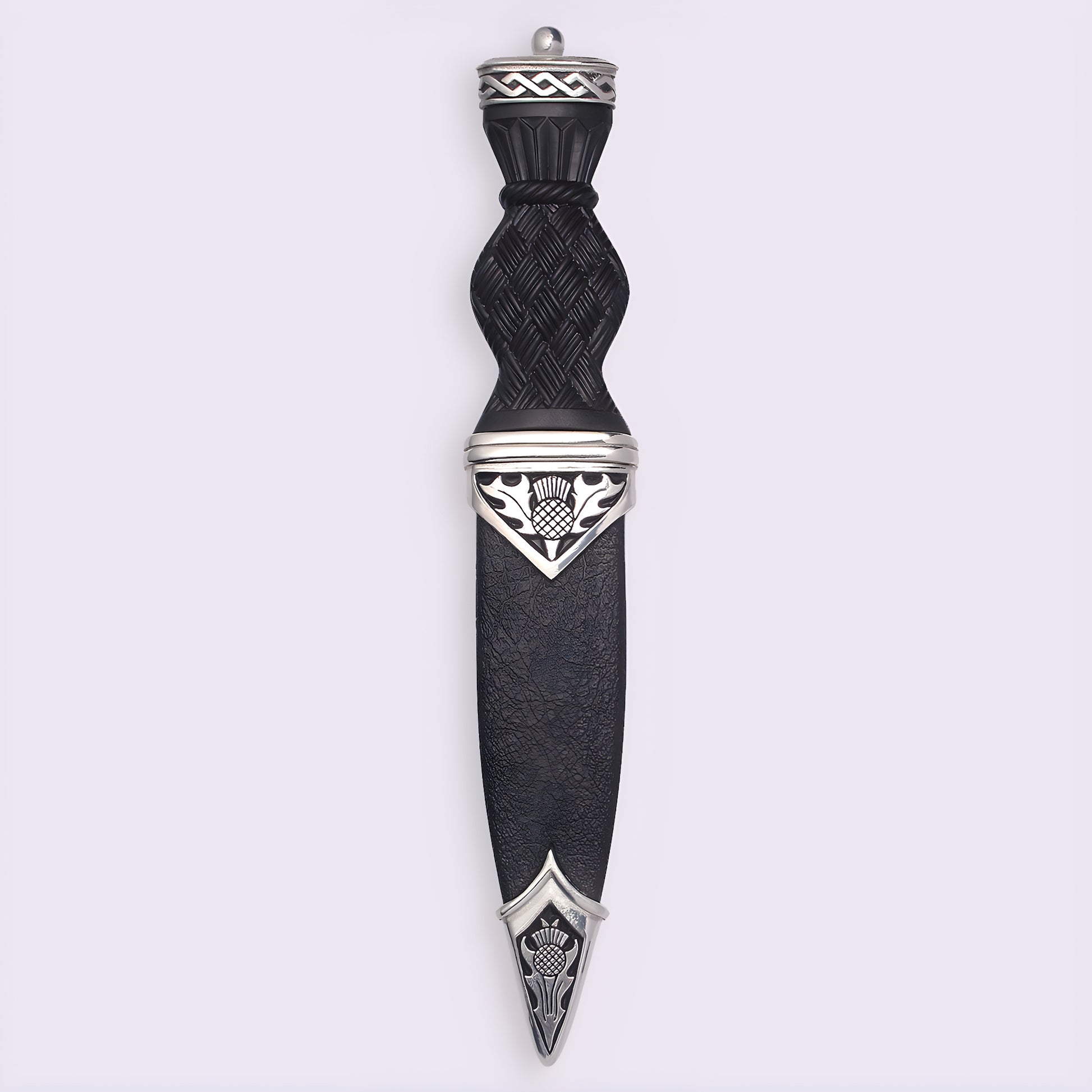 Traditional Scottish sgian dubh with black handle and thistle design.