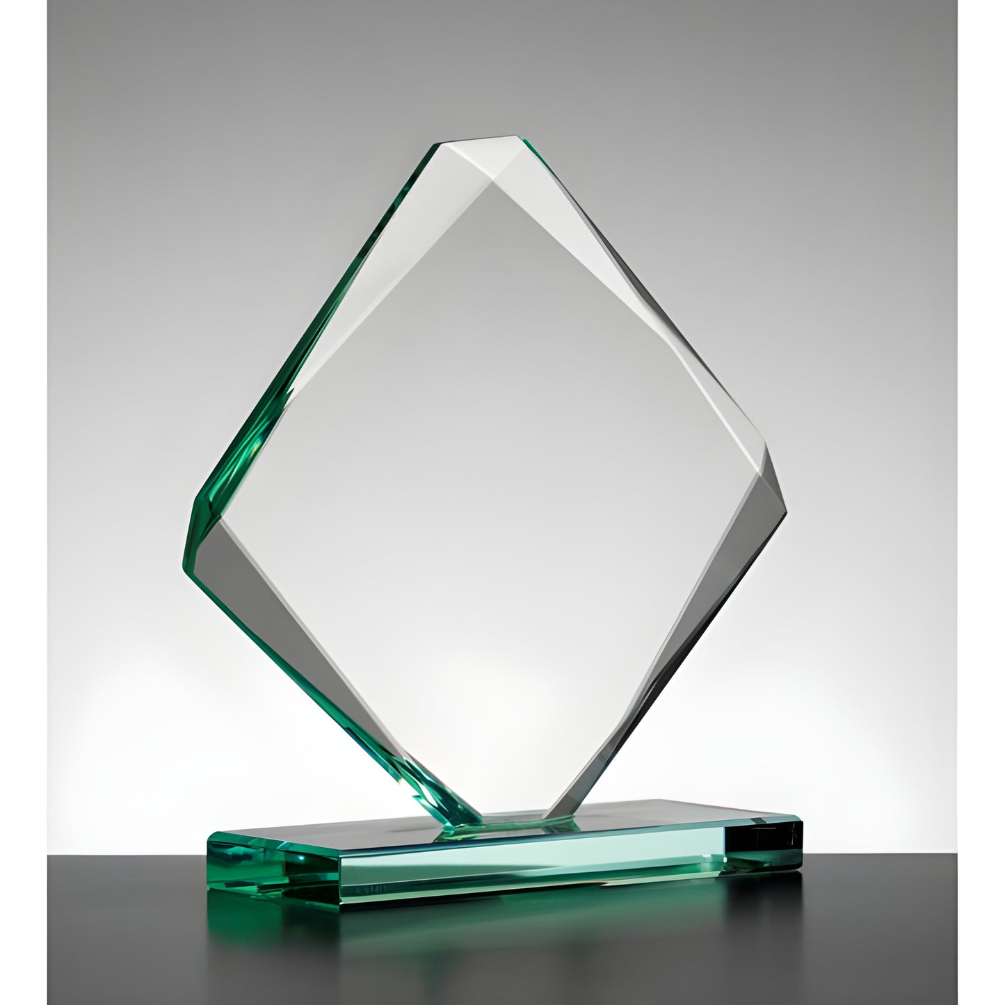 Clear emerald diamond-shaped glass award on a stand.