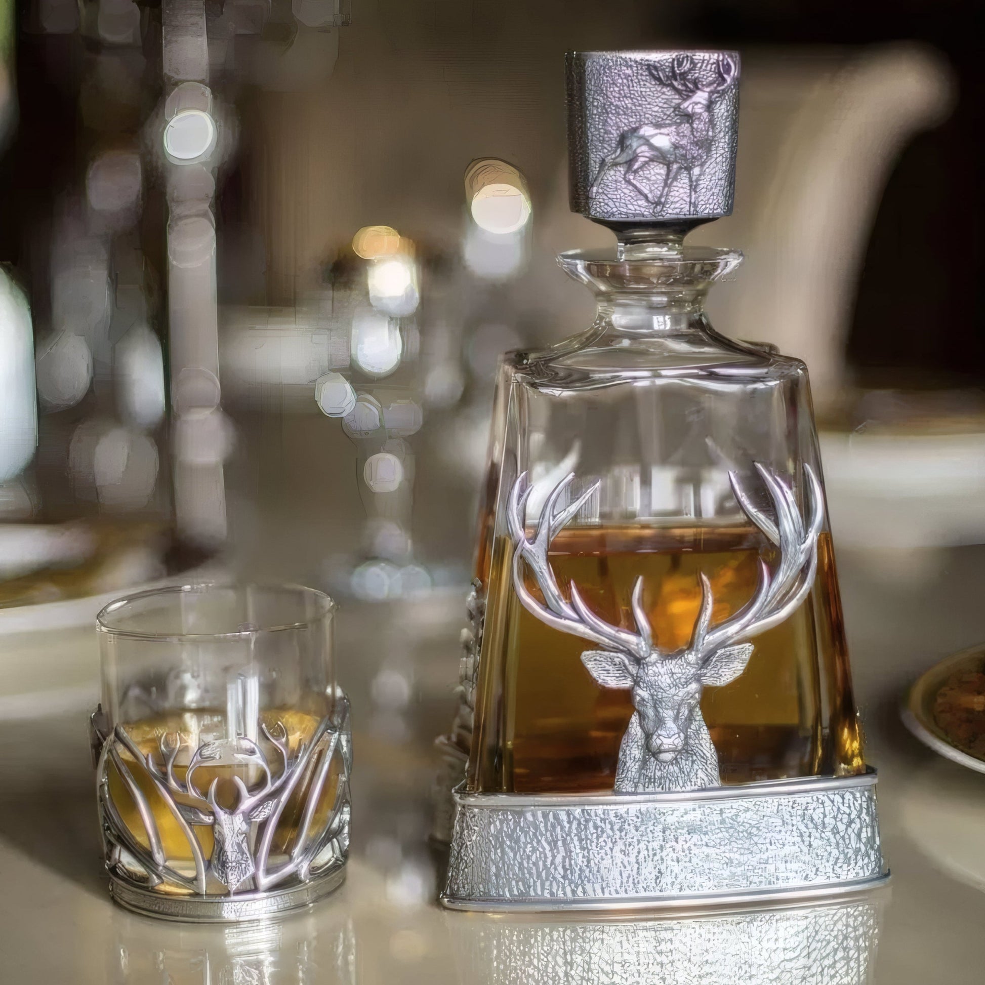 Elegant whisky decanter and glass with silver stag decoration.