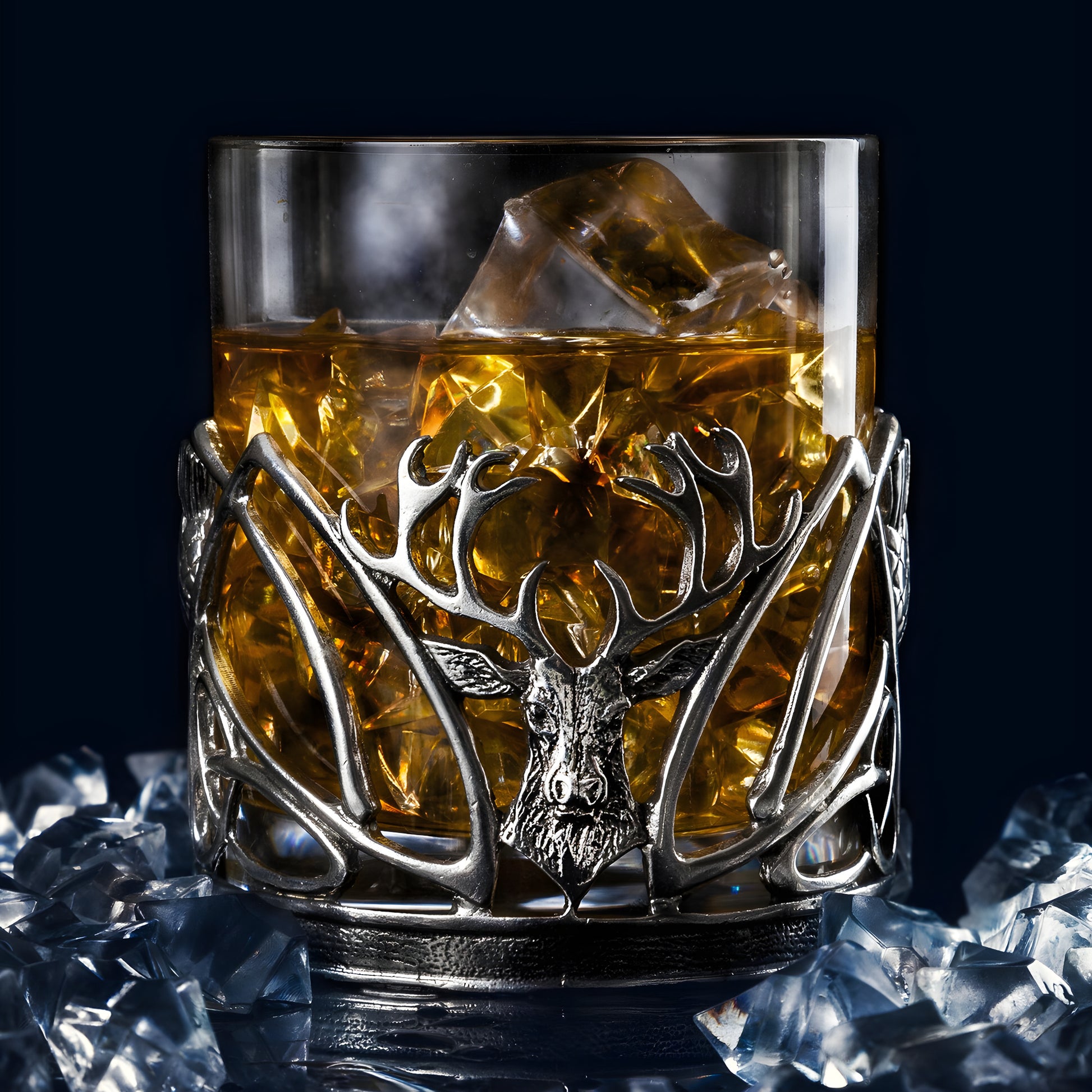 Decorative whisky glass with stag emblem and ice cubes.