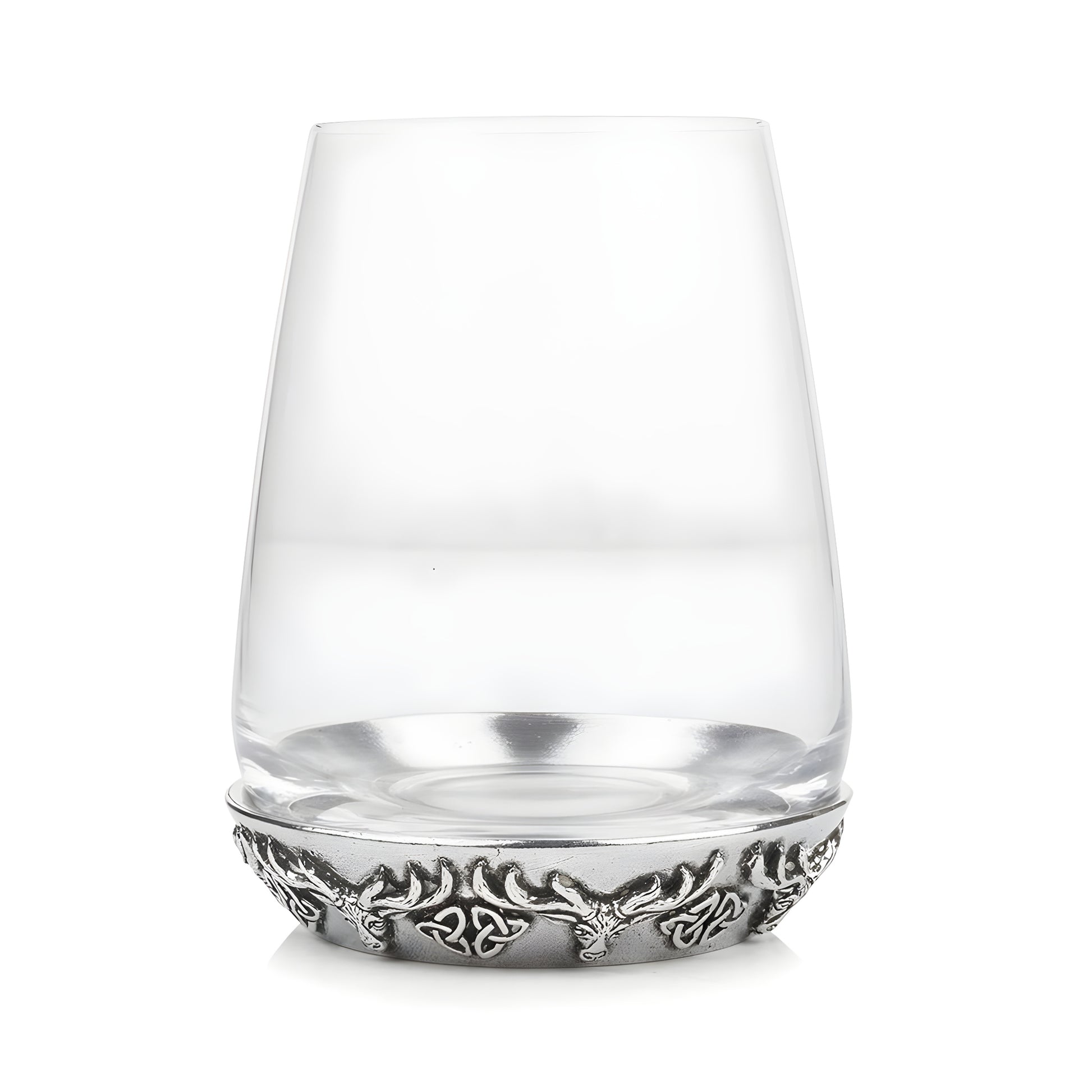 Clear glass tumbler with decorative antler design base.