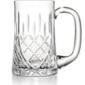 Close-up of a crystal beer mug with intricate etched patterns.