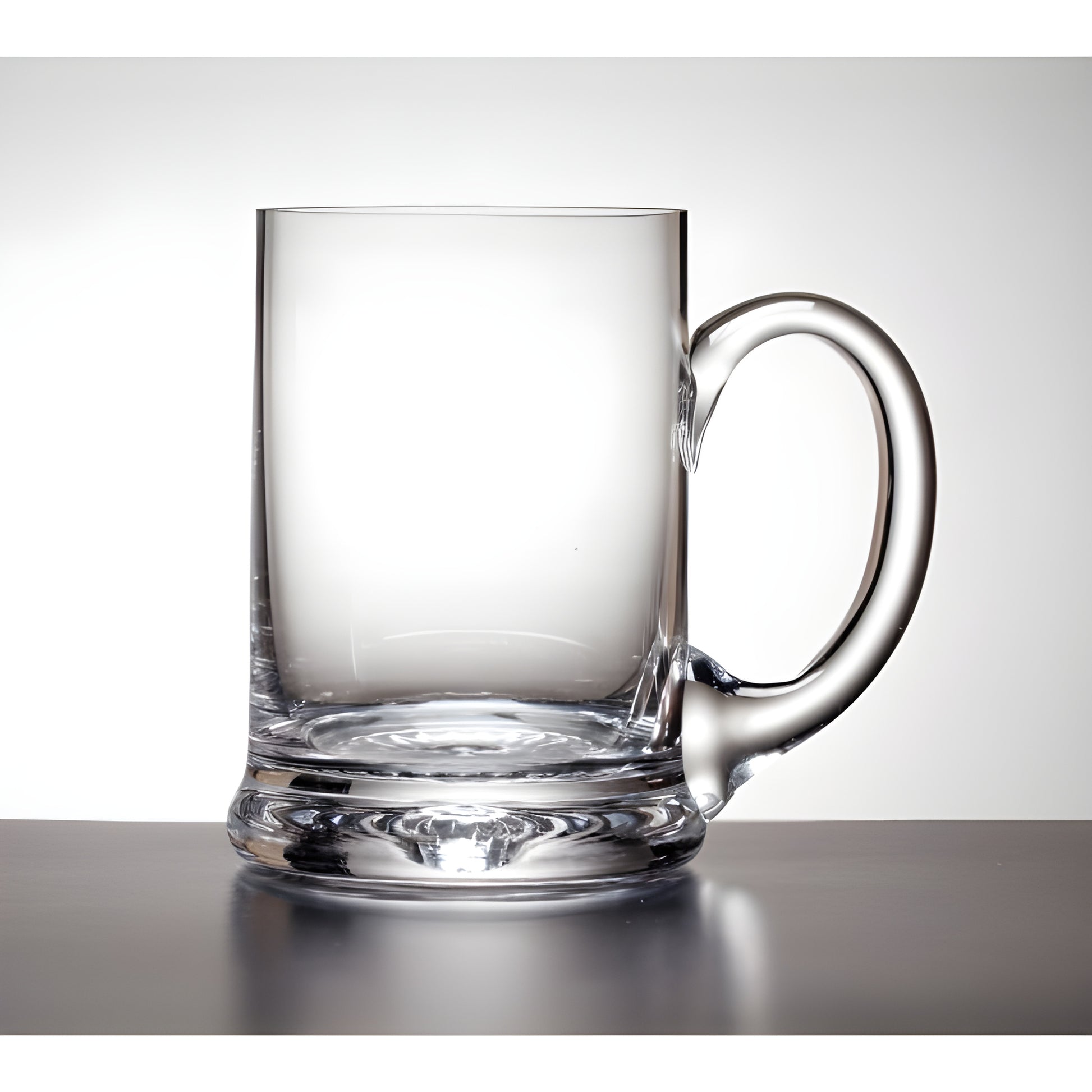 Clear glass tankard with handle on a reflective surface