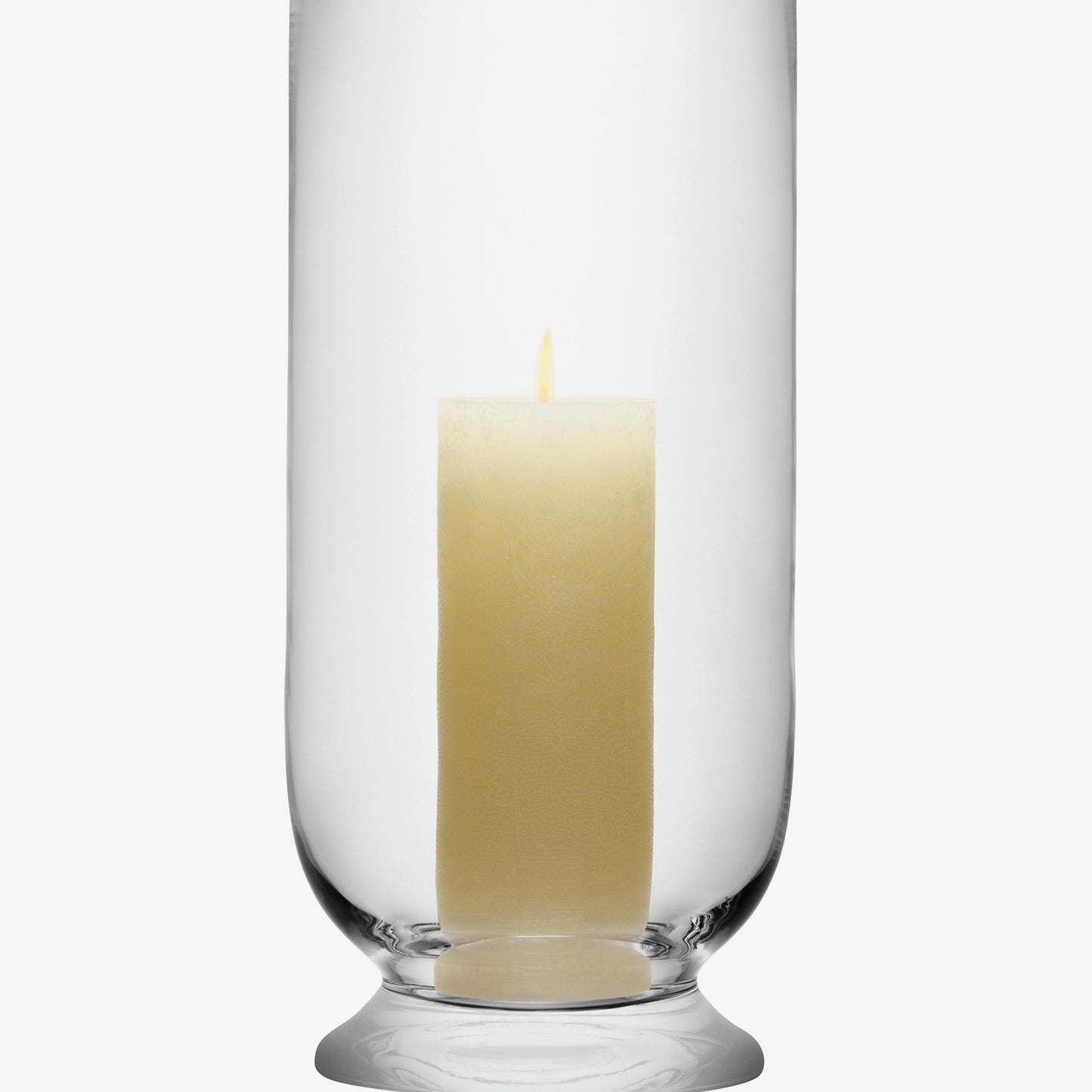 Glass hurricane candle holder with a lit white pillar candle.