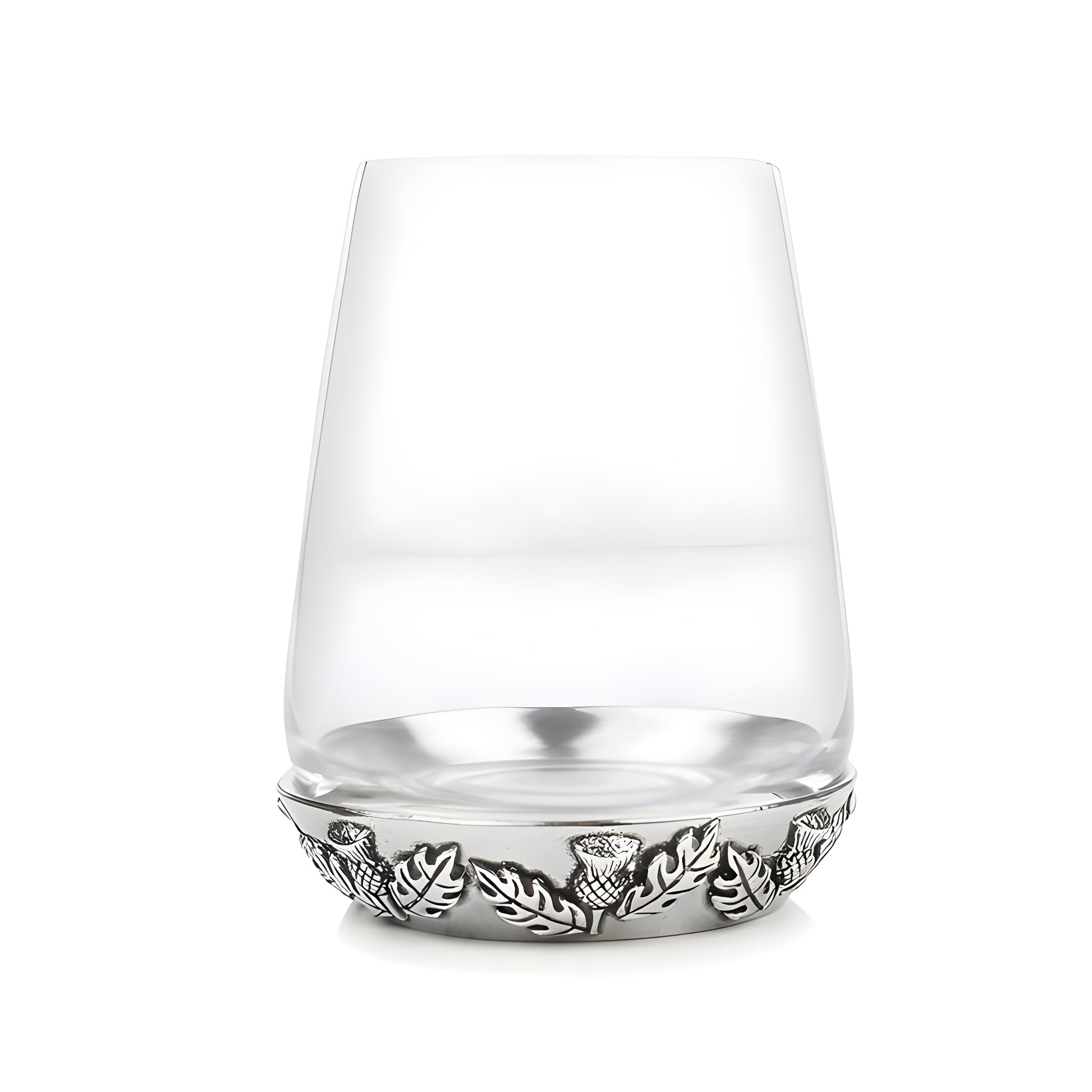 Crystal tumbler glass with engraved metal thistle design at base.