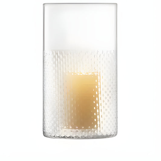 Textured glass cylinder vase with a lit candle inside.