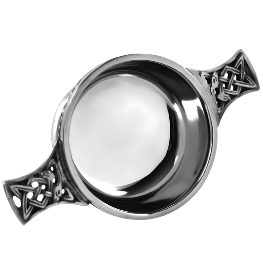 Pewter quaich bowl with Celtic knot handles, traditional Scottish design.