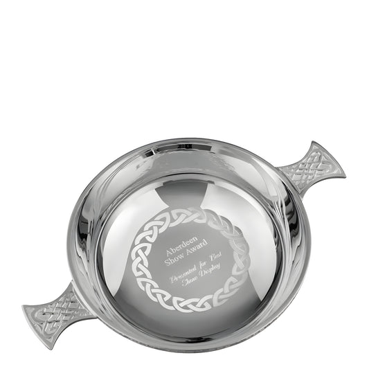 Silver Celtic quaich bowl award with intricate engravings and handles.