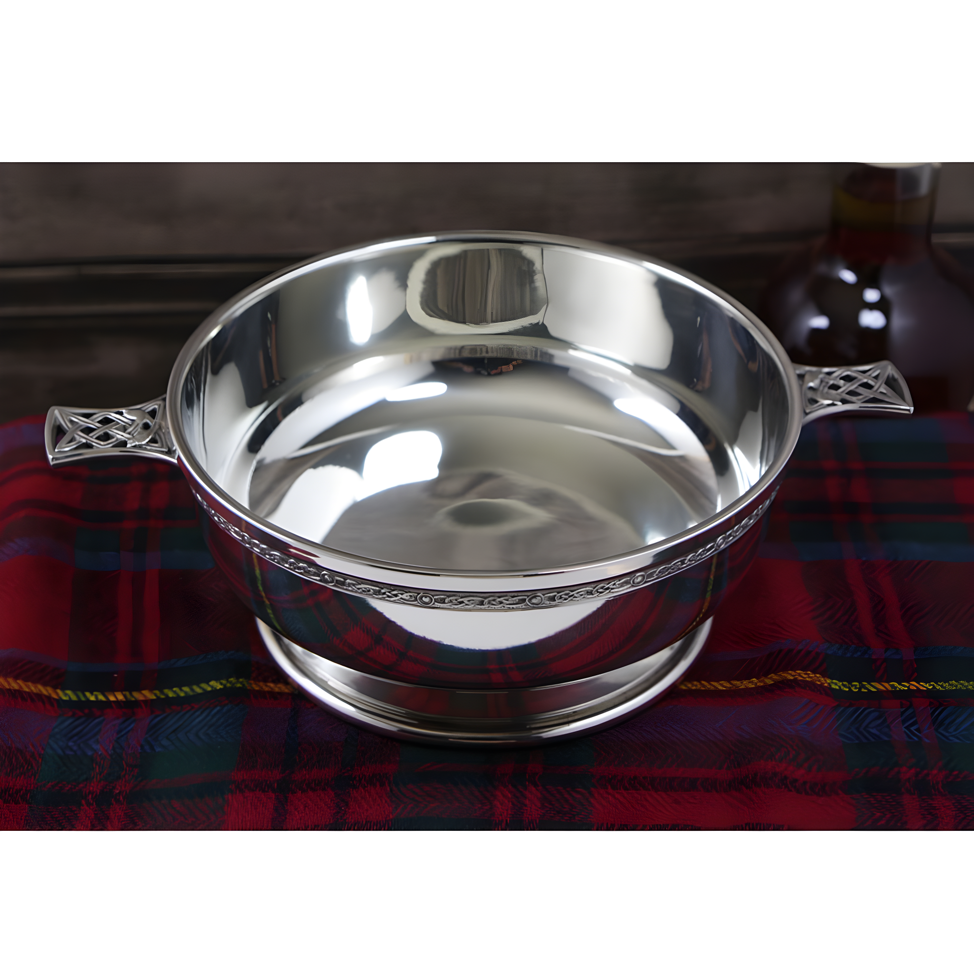 6.5-inch pewter quaich bowl with Celtic knot handles on tartan plaid
