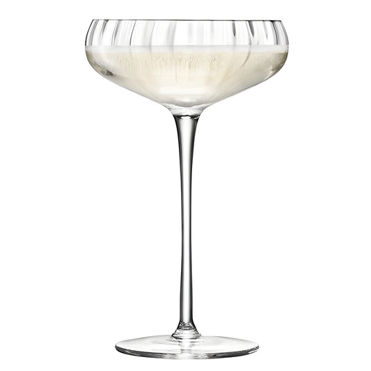 Elegant champagne saucer glass filled with sparkling wine