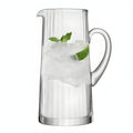 Clear glass pitcher with ice, lime slice, and mint leaves