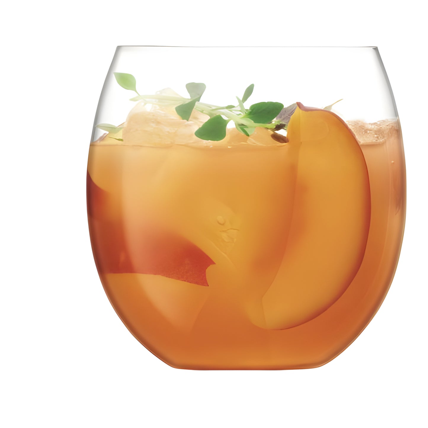 Glass of peach and herb cocktail with ice cubes.