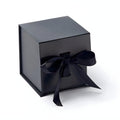Black cube gift box with ribbon tied elegantly for luxury packaging