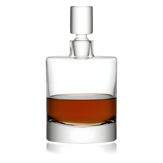Modern crystal decanter with whiskey, featuring a cylindrical shape and stopper.