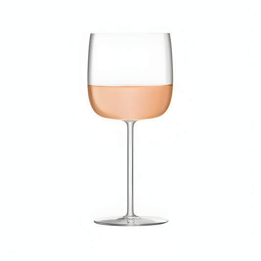 Elegant long-stem wine glass with rose wine on white background.