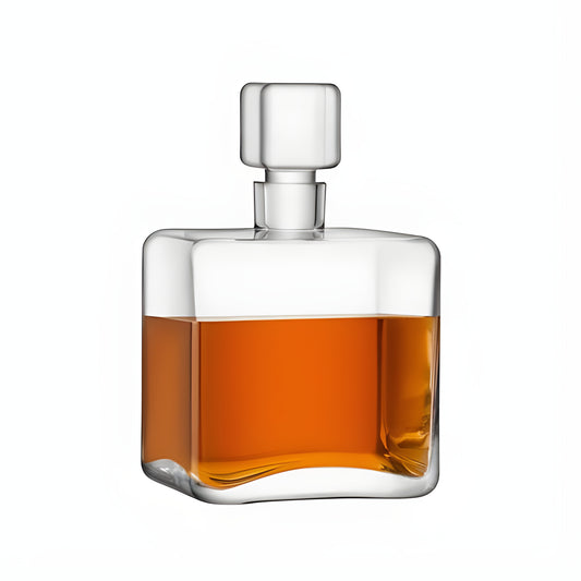 Square glass decanter filled with amber whisky on a white background.
