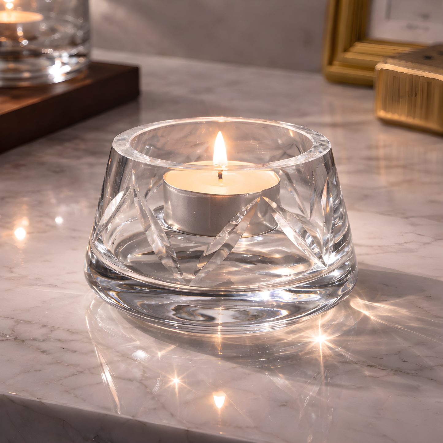 Crystal tealight holder with lit candle on marble surface.