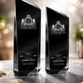 Black engraved recognition awards with Lion Royal logo on a reflective surface.