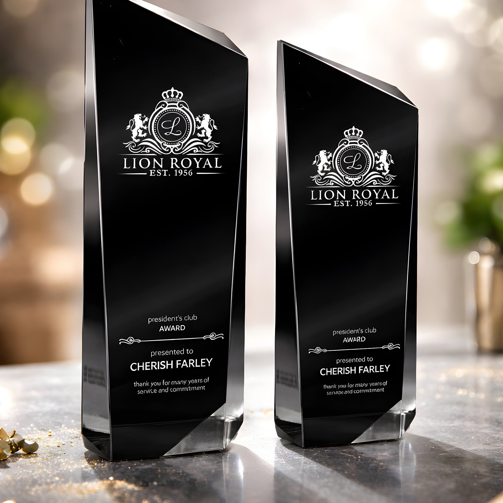 Black engraved recognition awards with Lion Royal logo on a reflective surface.