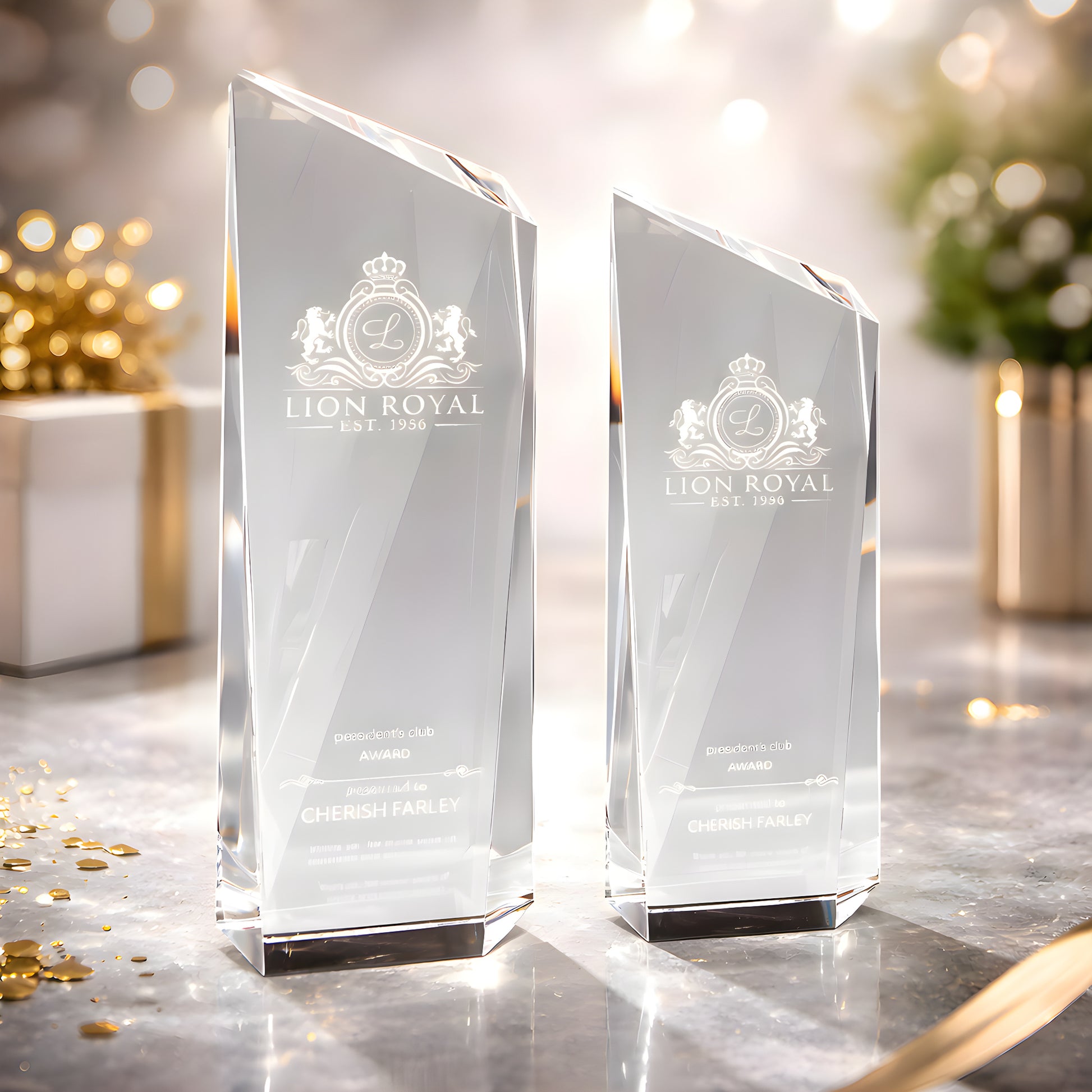 Clear glass awards with Lion Royal logo on a decorated table.